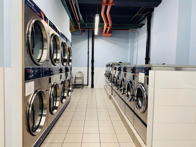 63-84 Saunders St Unit 2G, Rego Park, NY 11374 - community laundry with estacked washer and dryer, washer and clothes dryer, and light tile patterned flooring