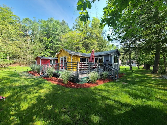39 E James Ave, Smallwood, NY 12778 - view of front of house featuring a deck, a front lawn, and a storage unit