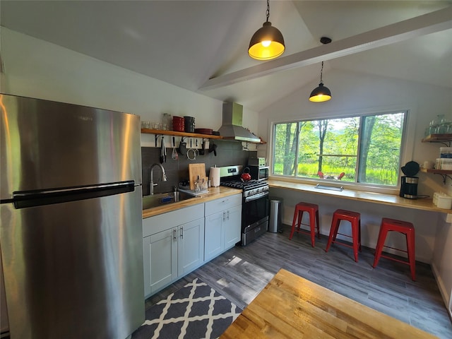 39 E James Ave, Smallwood, NY 12778 - kitchen with appliances with stainless steel finishes, wall chimney exhaust hood, open shelves, tasteful backsplash, and hanging light fixtures