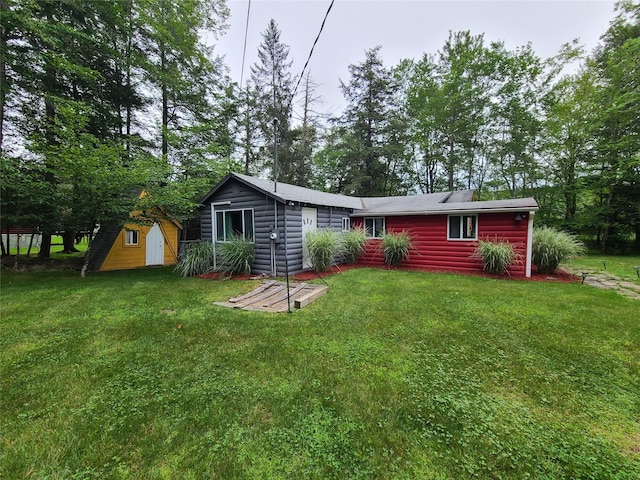 39 E James Ave, Smallwood, NY 12778 - view of front of property with a storage shed, a front yard, and log veneer siding