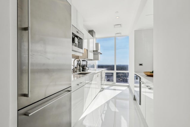 5 Renaissance Sq Unit Ph41G, White Plains, NY 10601 - kitchen featuring freestanding refrigerator, modern cabinets, floor to ceiling windows, white cabinets, and light tile patterned floors