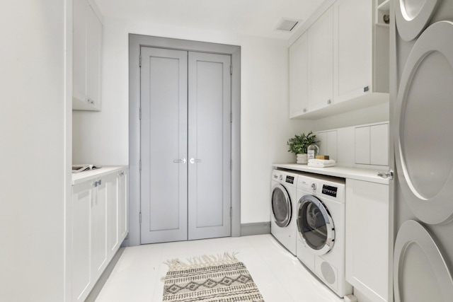 5 Renaissance Sq Unit Ph41G, White Plains, NY 10601 - laundry area featuring washing machine and dryer, cabinet space, and light tile patterned floors