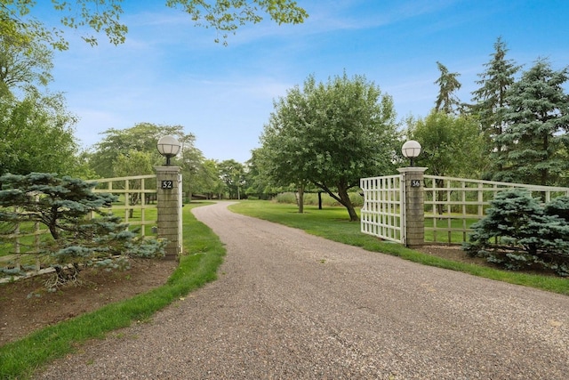 56 Tuthill Point Rd, East Moriches, NY 11940 - view of dirt / gravel driveway with street lights