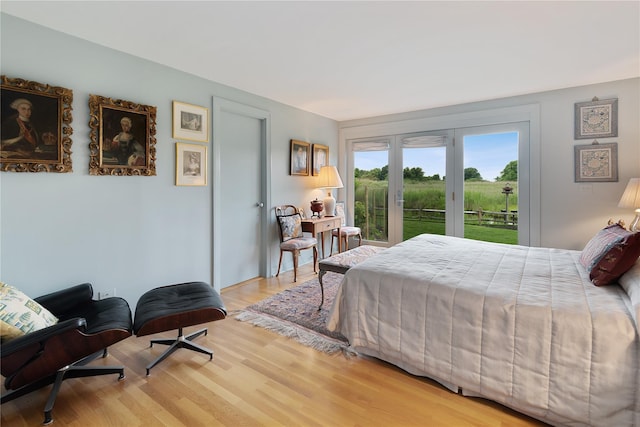 56 Tuthill Point Rd, East Moriches, NY 11940 - bedroom with access to exterior, wood finished floors, and french doors