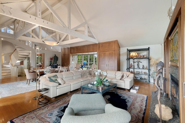 56 Tuthill Point Rd, East Moriches, NY 11940 - living room featuring stairs, high vaulted ceiling, plenty of natural light, and light wood-type flooring