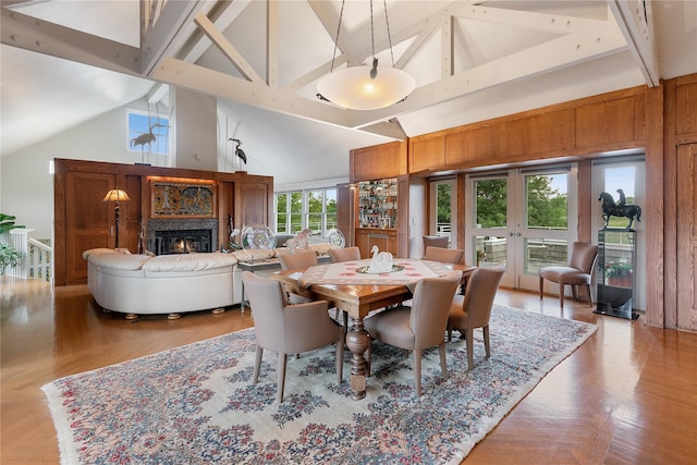 56 Tuthill Point Rd, East Moriches, NY 11940 - dining space featuring a warm lit fireplace, beam ceiling, and high vaulted ceiling
