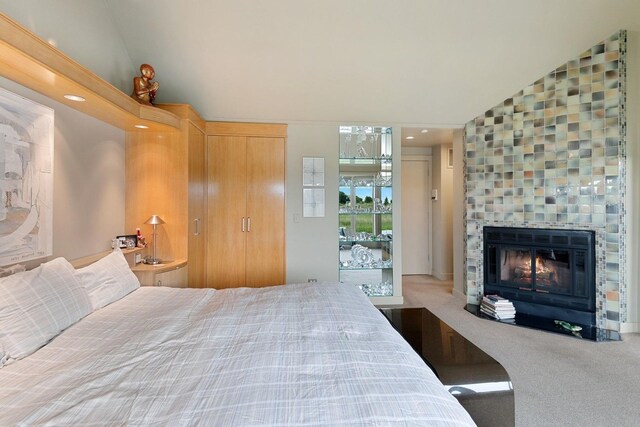 56 Tuthill Point Rd, East Moriches, NY 11940 - bedroom with a fireplace, carpet, and vaulted ceiling