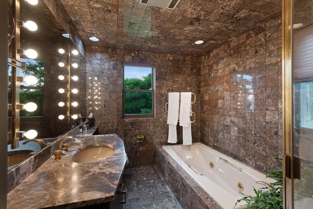 56 Tuthill Point Rd, East Moriches, NY 11940 - bathroom featuring a tub with jets, vanity, and tile walls