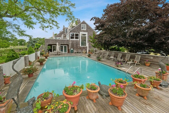 56 Tuthill Point Rd, East Moriches, NY 11940 - view of swimming pool featuring a wooden deck and a fenced backyard