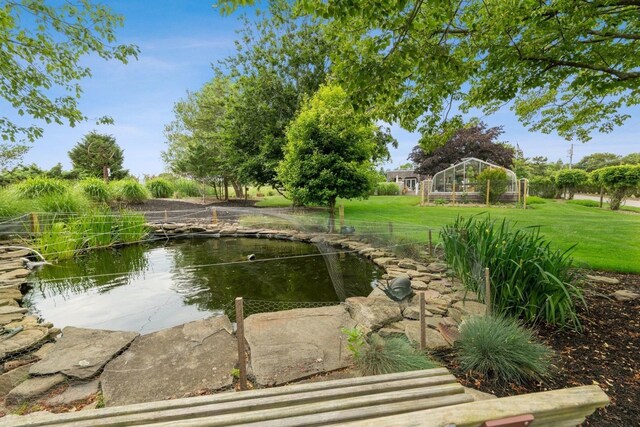 56 Tuthill Point Rd, East Moriches, NY 11940 - surrounding community featuring a yard and a garden pond