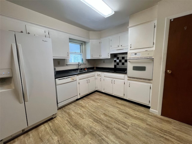 39 Hilltop Ln, Narrowsburg, NY 12764 - kitchen with white appliances, under cabinet range hood, dark countertops, light wood-style flooring, and white cabinets