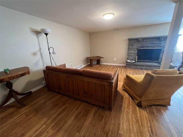 39 Hilltop Ln, Narrowsburg, NY 12764 - living room featuring wood finished floors, a fireplace, and a baseboard heating unit