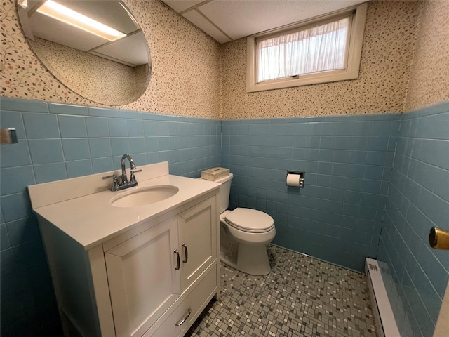 39 Hilltop Ln, Narrowsburg, NY 12764 - bathroom featuring wallpapered walls, tile walls, wainscoting, vanity, and tile patterned flooring