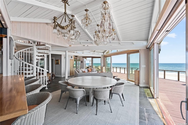 174 Dune Rd, Quogue, NY 11959 - dining area with a chandelier, a water view, plenty of natural light, and wooden ceiling