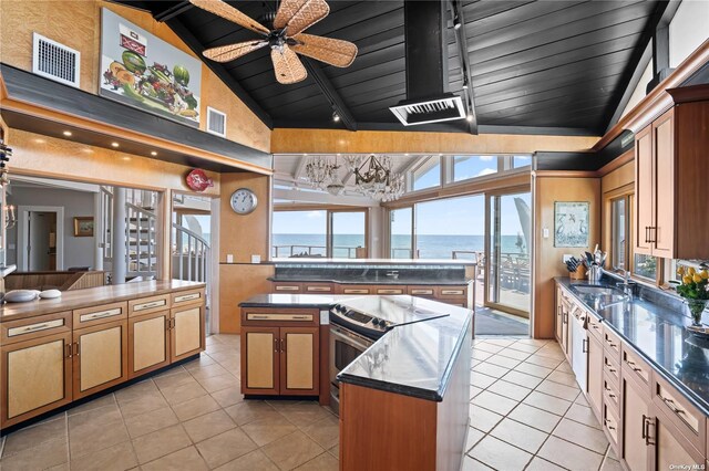 174 Dune Rd, Quogue, NY 11959 - kitchen featuring electric stove, a wooden ceiling with exposed beams, a center island, light tile patterned flooring, and ceiling fan