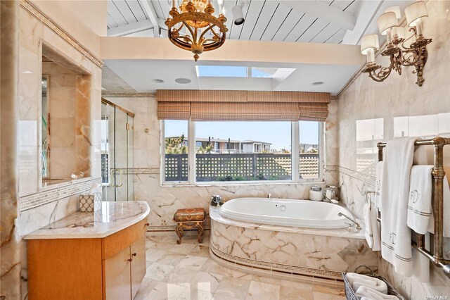 174 Dune Rd, Quogue, NY 11959 - bathroom featuring tile walls, a bath, a shower stall, a chandelier, and marble finish floors