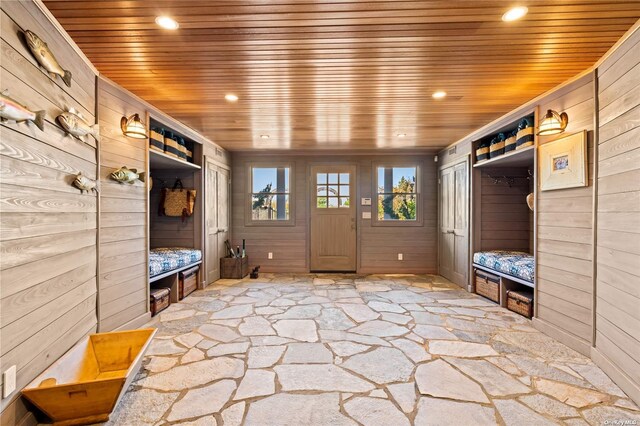 174 Dune Rd, Quogue, NY 11959 - mudroom featuring wood ceiling, stone flooring, wooden walls, and recessed lighting