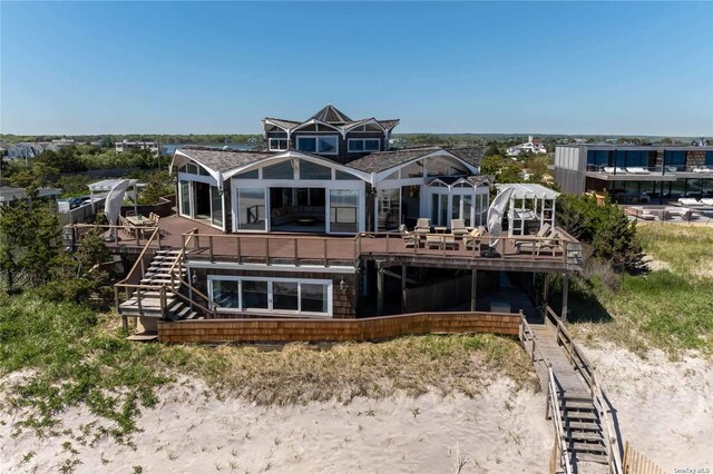 174 Dune Rd, Quogue, NY 11959 - rear view of house with a deck and stairway