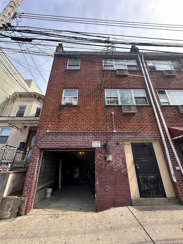 9444 45th Ave, Elmhurst, NY 11373 - view of building exterior featuring concrete driveway and a garage