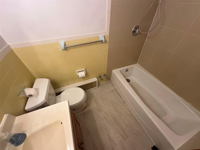 9444 45th Ave, Elmhurst, NY 11373 - full bath with tile walls, pet washing area, wainscoting, washtub / shower combination, and vanity