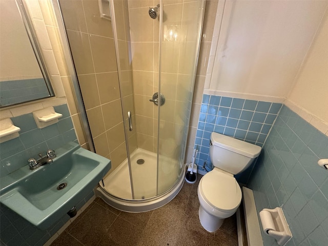 9444 45th Ave, Elmhurst, NY 11373 - bathroom with tile walls, a stall shower, a wainscoted wall, and baseboard heating