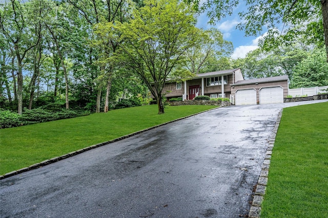 38 Mcarthur Ln, Smithtown, NY 11787 - split foyer home with asphalt driveway, a garage, and a front lawn