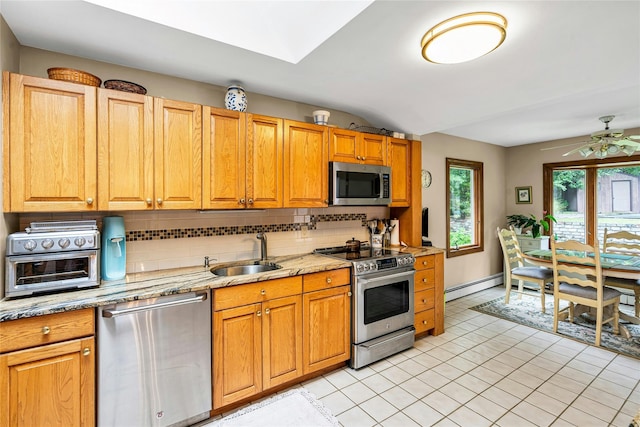 38 Mcarthur Ln, Smithtown, NY 11787 - kitchen featuring appliances with stainless steel finishes, tasteful backsplash, baseboard heating, a ceiling fan, and light stone countertops