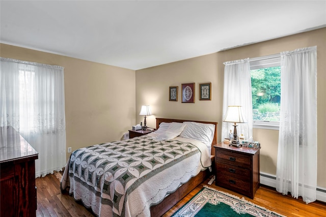 38 Mcarthur Ln, Smithtown, NY 11787 - bedroom with wood finished floors and a baseboard heating unit