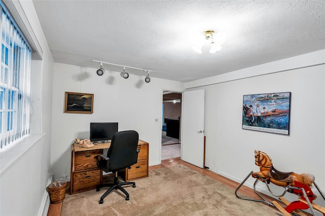38 Mcarthur Ln, Smithtown, NY 11787 - office area with track lighting, a textured ceiling, and light wood finished floors