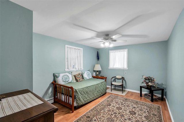 38 Mcarthur Ln, Smithtown, NY 11787 - bedroom with light wood finished floors, a ceiling fan, and baseboard heating