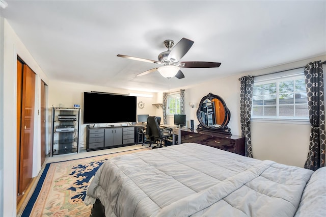 41 Meridian Rd, Levittown, NY 11756 - bedroom with multiple windows, ceiling fan, an office area, and wood finished floors