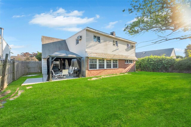 41 Meridian Rd, Levittown, NY 11756 - back of property featuring a gazebo, a patio area, brick siding, a fenced backyard, and a chimney