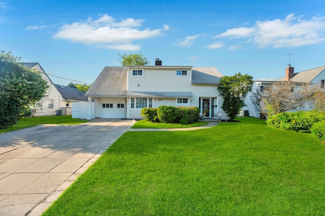 41 Meridian Rd, Levittown, NY 11756 - view of front of house featuring a front lawn, an attached garage, a chimney, and concrete driveway