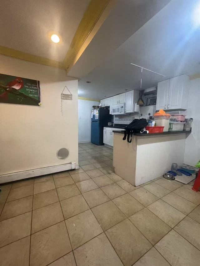103-23 51st Ave, Corona, NY 11368 - kitchen featuring white microwave, freestanding refrigerator, baseboard heating, dark countertops, and a peninsula