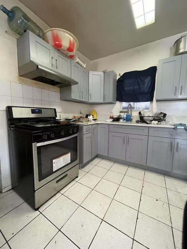 103-23 51st Ave, Corona, NY 11368 - kitchen featuring gas stove, under cabinet range hood, gray cabinetry, and light countertops