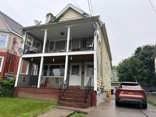 69 Delafield St, Poughkeepsie, NY 12601 - view of front of property with a balcony and covered porch