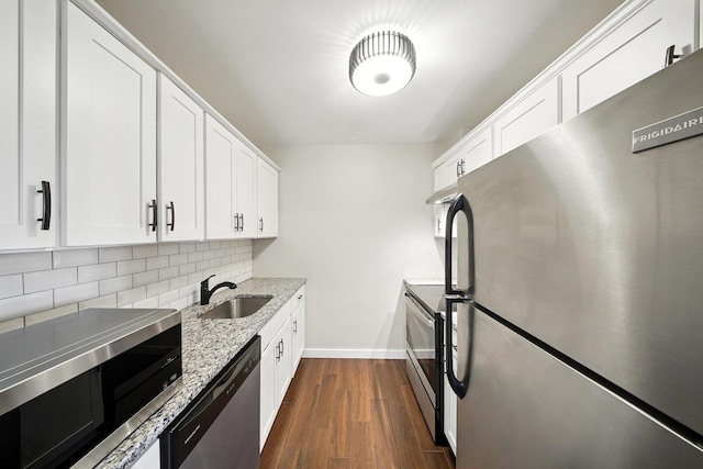 42 Inwood Rd, Middletown, NY 10941 - kitchen featuring appliances with stainless steel finishes, decorative backsplash, dark wood finished floors, white cabinets, and light stone counters