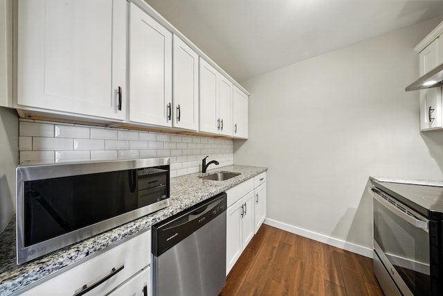 42 Inwood Rd, Middletown, NY 10941 - kitchen featuring appliances with stainless steel finishes, backsplash, dark wood-style floors, light stone counters, and white cabinetry