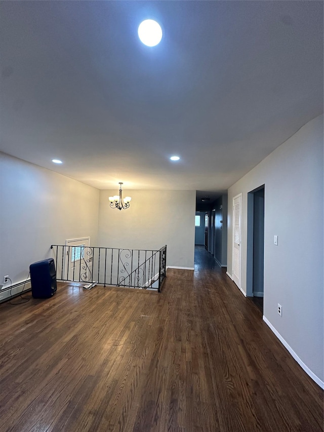 3666 Illona Ln, Oceanside, NY 11572 - unfurnished room with dark wood-style flooring, a chandelier, and recessed lighting