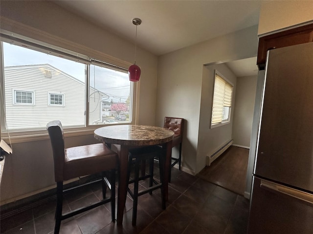 3666 Illona Ln, Oceanside, NY 11572 - dining room featuring a baseboard radiator, healthy amount of natural light, and dark tile patterned floors