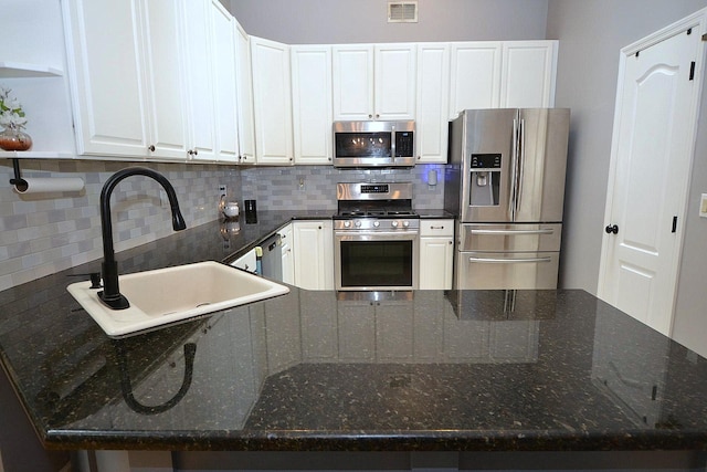 1405 Constance Ln, Port Jefferson Station, NY 11776 - kitchen featuring appliances with stainless steel finishes, backsplash, and white cabinetry