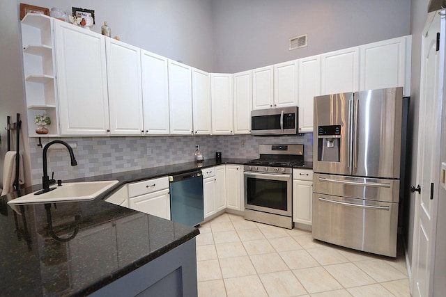1405 Constance Ln, Port Jefferson Station, NY 11776 - kitchen featuring stainless steel appliances, light tile patterned floors, backsplash, open shelves, and a high ceiling