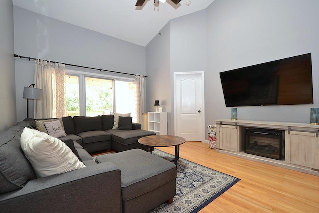 1405 Constance Ln, Port Jefferson Station, NY 11776 - living room featuring high vaulted ceiling, light wood-style floors, a ceiling fan, and a fireplace