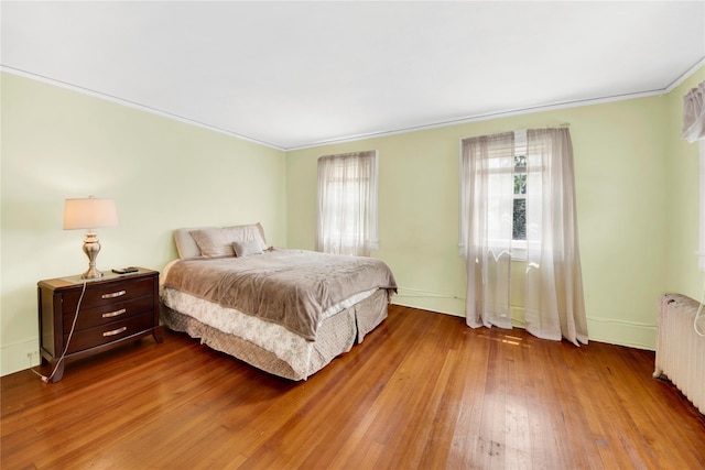 431 E Sidney Ave, Mount Vernon, NY 10553 - bedroom featuring wood finished floors, radiator heating unit, and ornamental molding
