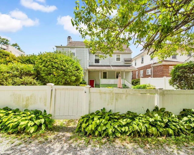 431 E Sidney Ave, Mount Vernon, NY 10553 - view of front of property with a fenced front yard, a porch, and a chimney