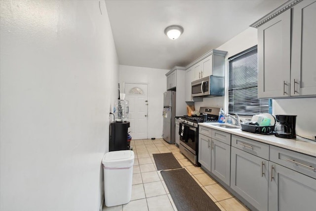 317 Hawthorne Ave, Yonkers, NY 10705 - kitchen featuring stainless steel appliances, gray cabinetry, light countertops, and light tile patterned floors