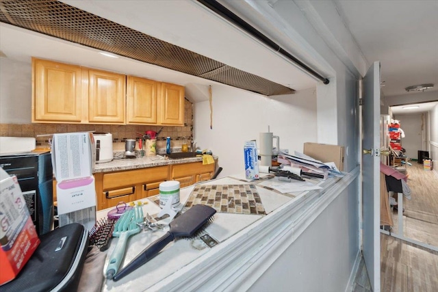 317 Hawthorne Ave, Yonkers, NY 10705 - kitchen with wood finished floors, decorative backsplash, light brown cabinetry, and light countertops