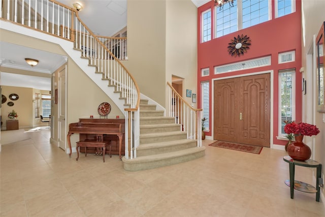 35 Monterrey Dr, Saint James, NY 11780 - entryway featuring a high ceiling, stairway, ornamental molding, and tile patterned flooring