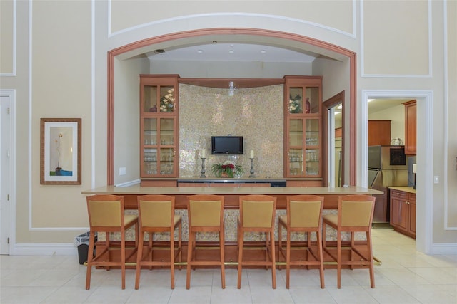 35 Monterrey Dr, Saint James, NY 11780 - bar featuring backsplash and light tile patterned floors