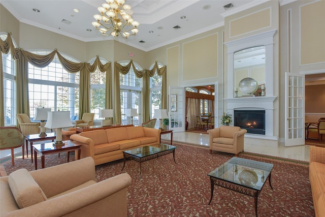 35 Monterrey Dr, Saint James, NY 11780 - living area featuring a chandelier, a glass covered fireplace, ornamental molding, a high ceiling, and a decorative wall